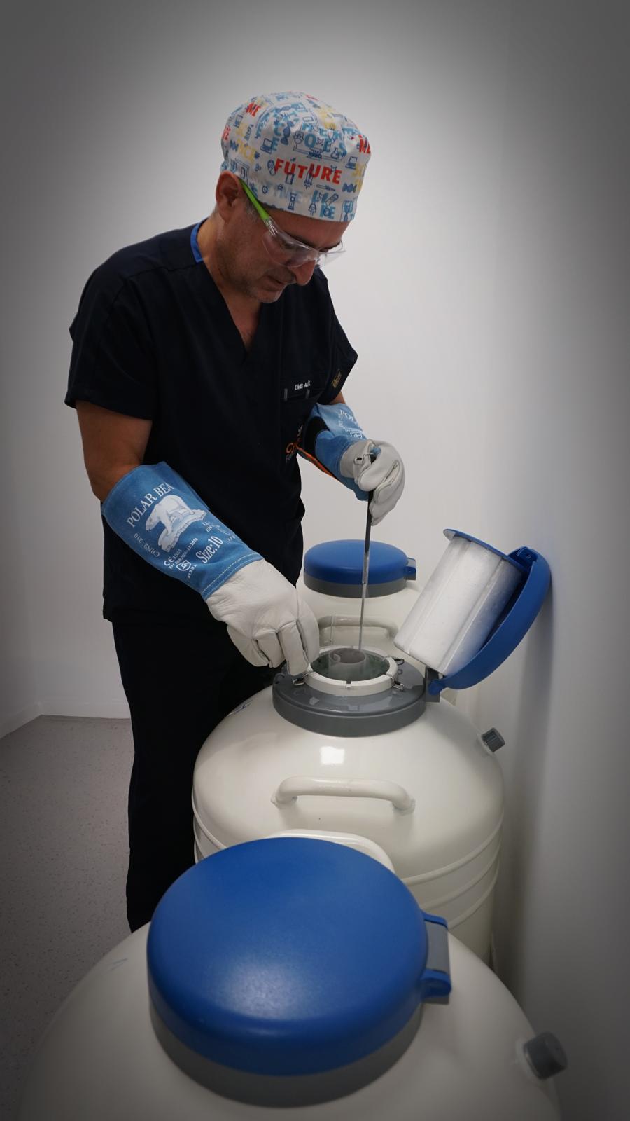Embryologist at the cryostorage tanks in the Fertina IVF laboratory
