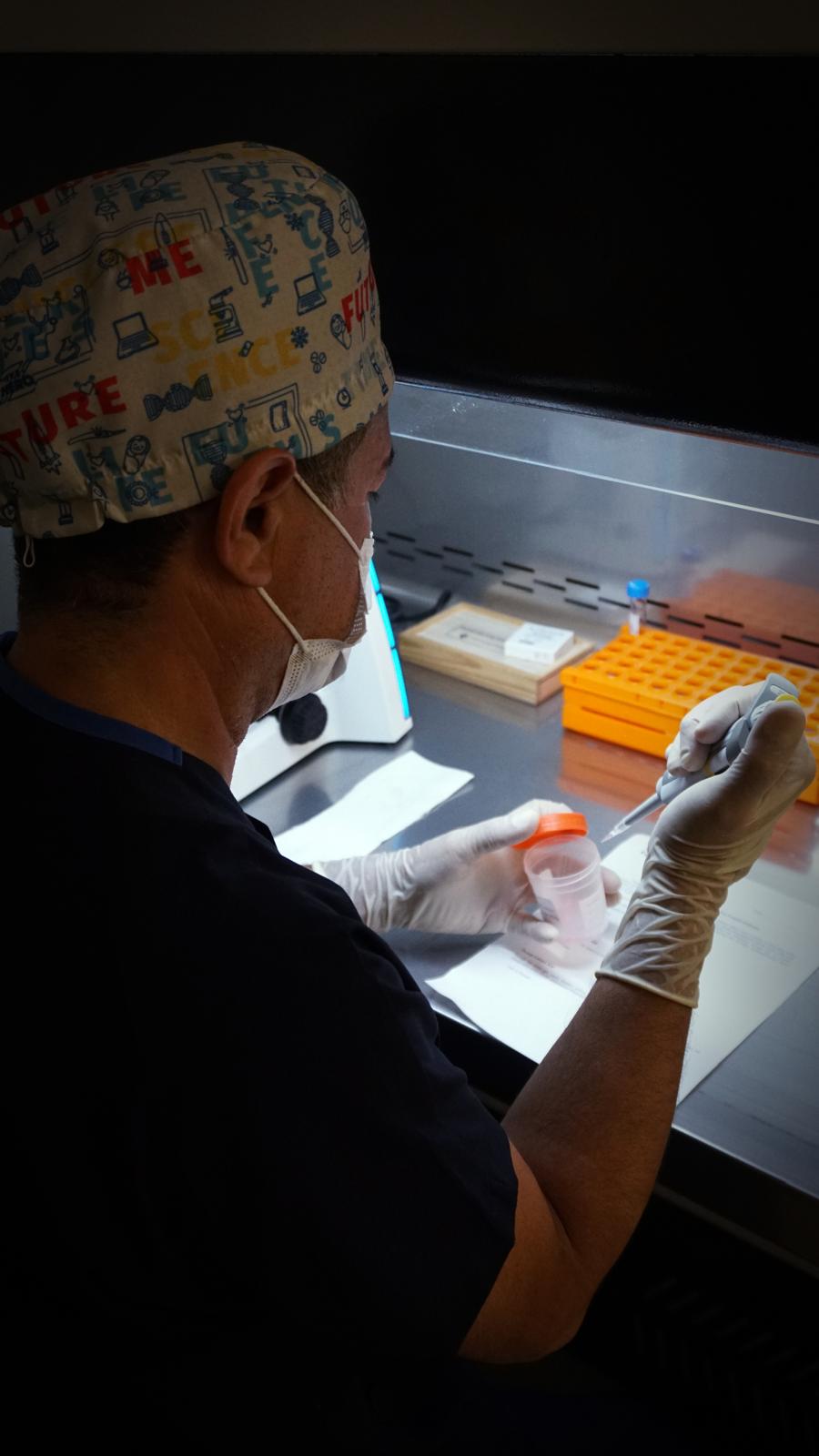Embryologist working under the laminar flow hood at Fertina IVF